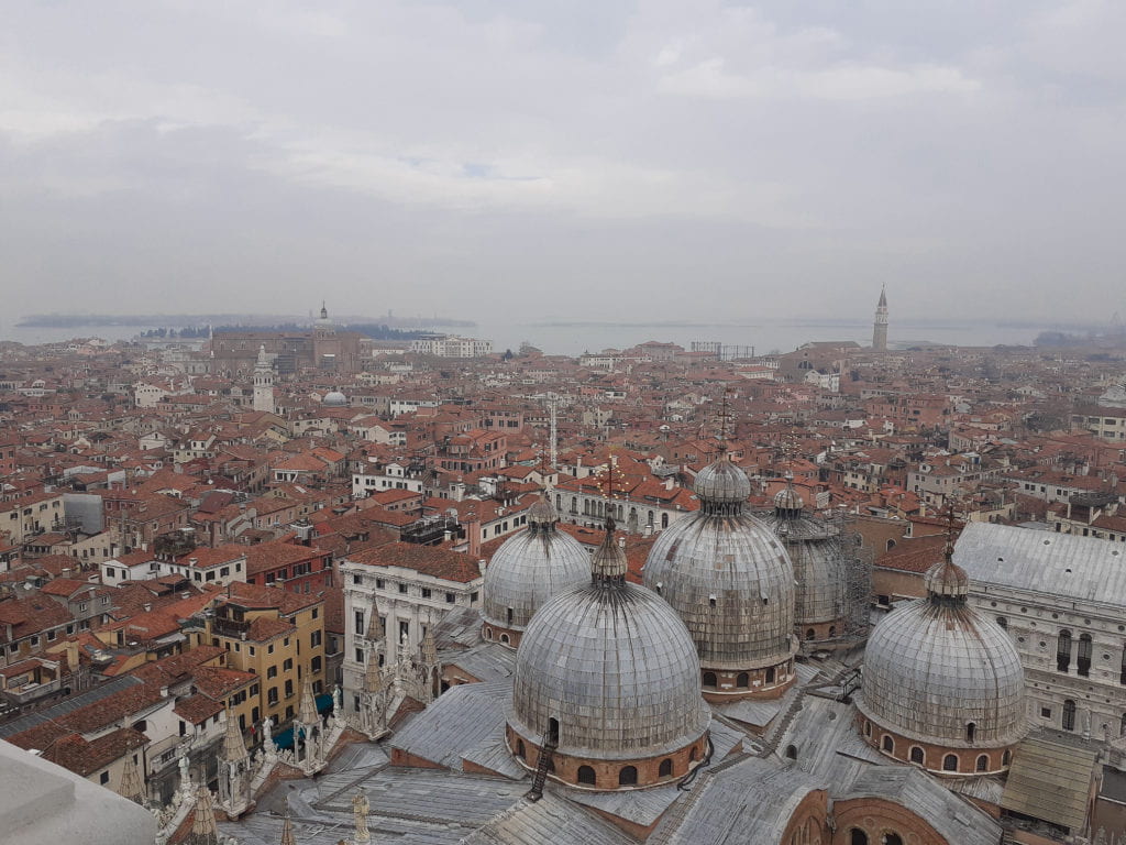 The view from the top of St Mark's Campanile, on the side overlooking St Mark's Basilica, which provides a stunning aerial view of Venice.